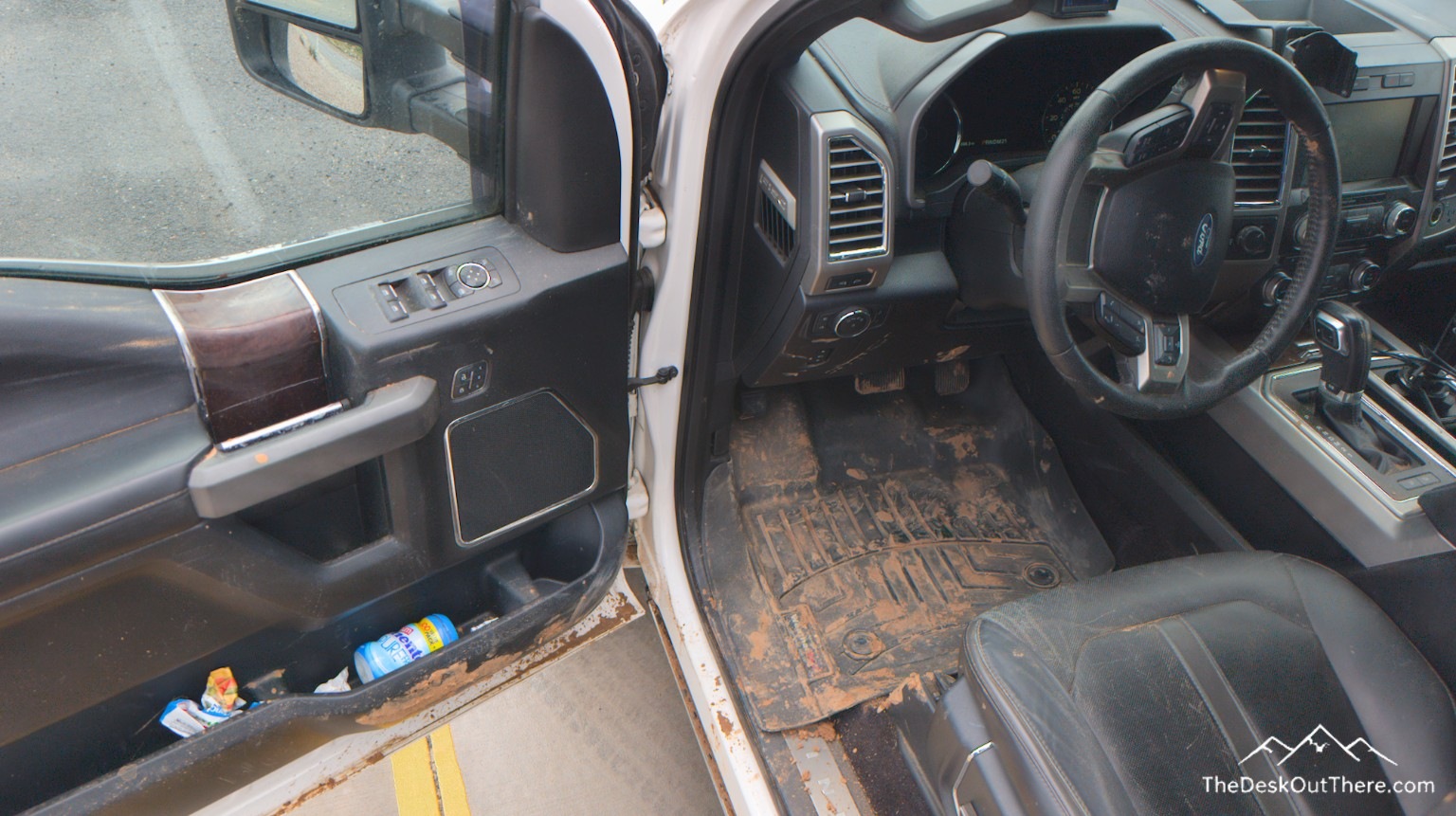 Mud covering the driver footwell and door sill after the recovery.