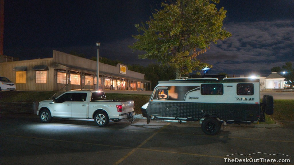 Truck and camper parked outside a Cracker Barrel at night during the first overnight stop.