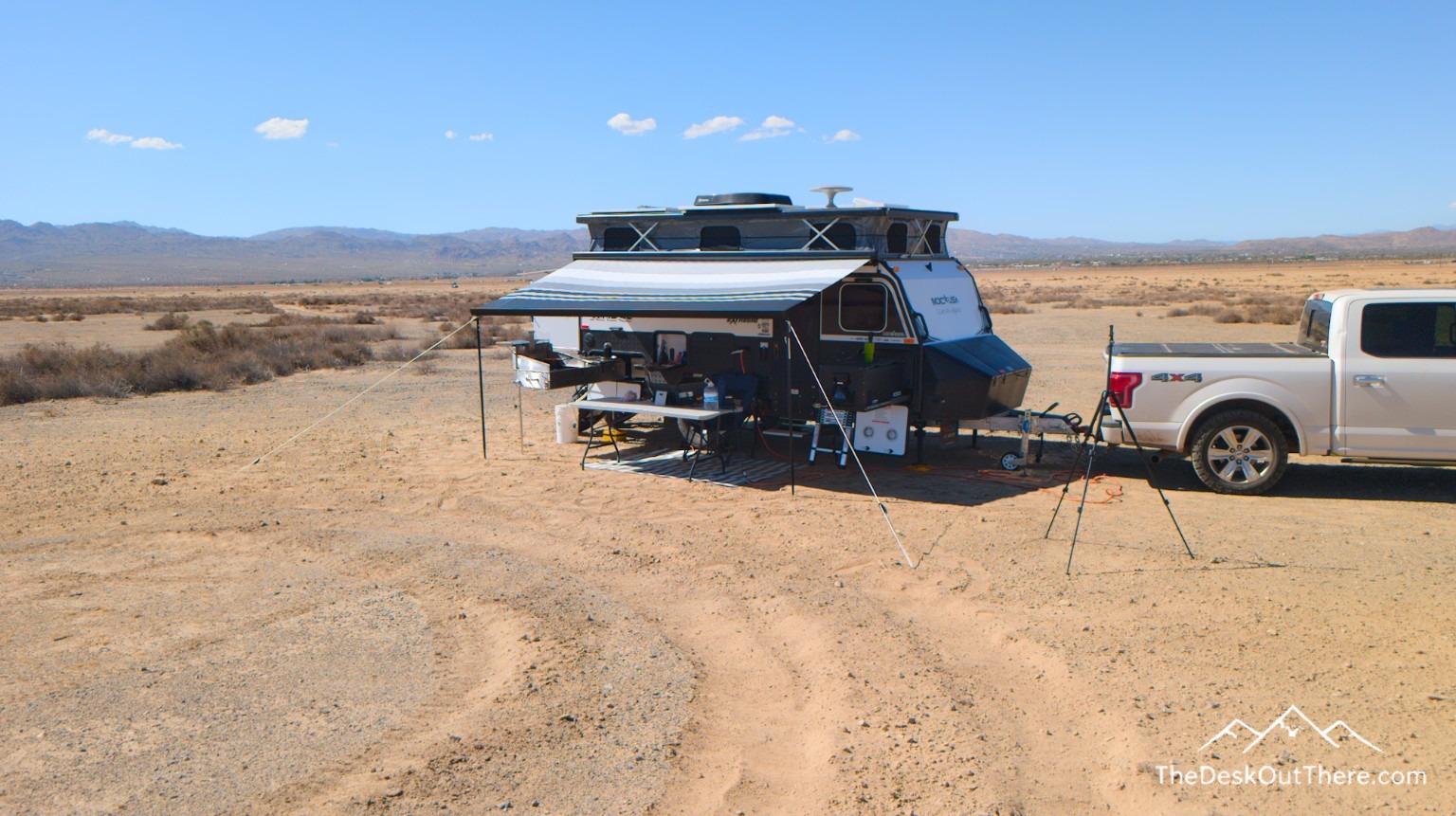 Camper and outdoor desk set up in the California desert